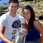 Phil Ashley and Emma Topham with the message in a bottle at Bundeena