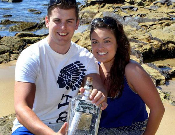 Phil Ashley and Emma Topham with the message in a bottle at Bundeena